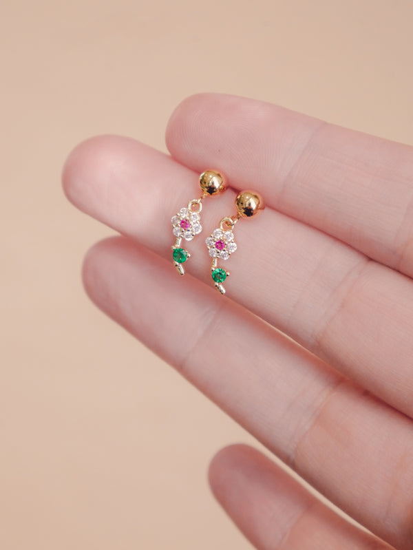 These Mini Flōra earrings, with their small flowers and dainty stones, add a touch of whimsy to any outfit. Perfect for everyday wear or layering for our multi-piercing peeps.  Gold-filled ear hooks or ball studs  14k plated CZ crystal daisy drops 2.5cm total length  Suitable for sensitive skin 