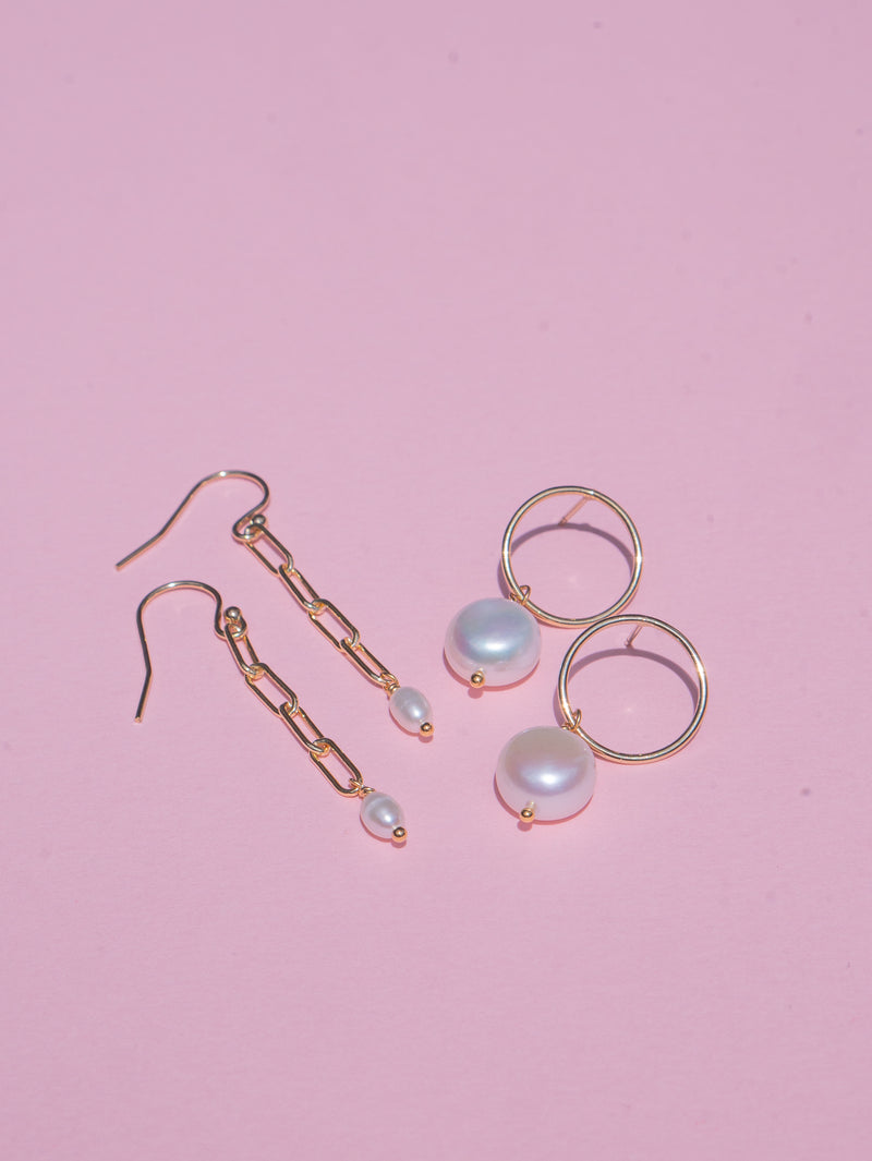 White freshwater pearls freely hang from gold-filled circle stud and chain earrings. Also available in sterling silver.