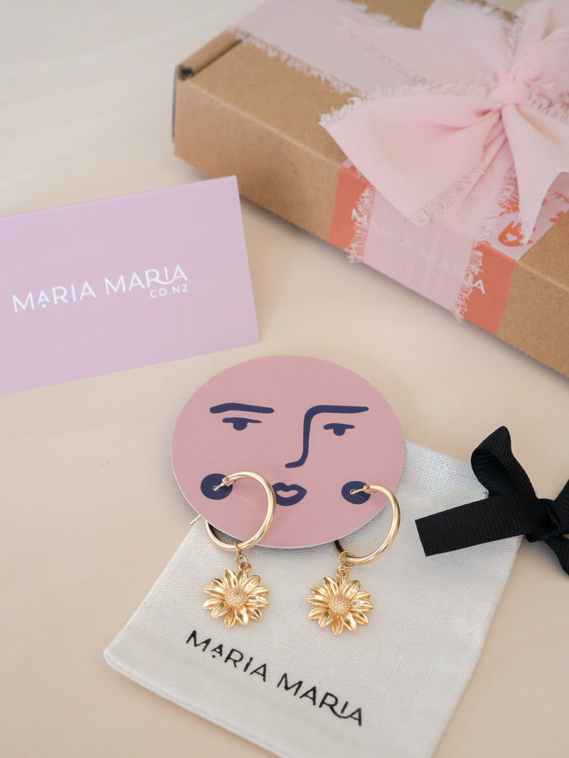 Gold-filled hoop earrings with sunflower charms gift packaging
