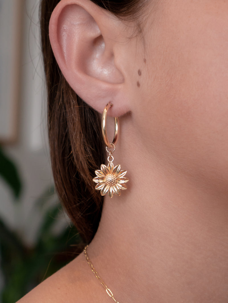 Gold-filled hoop earrings with sunflower charms 